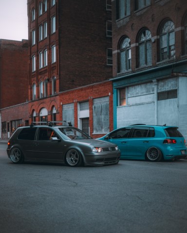 two lowered VW cars parked