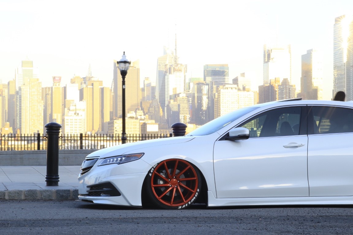 lowered white car with tucked red rims