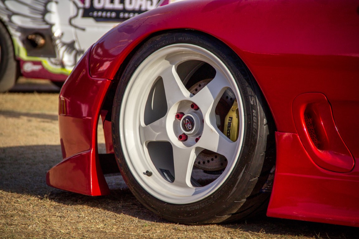 red thick five spoke rims on a lowered car