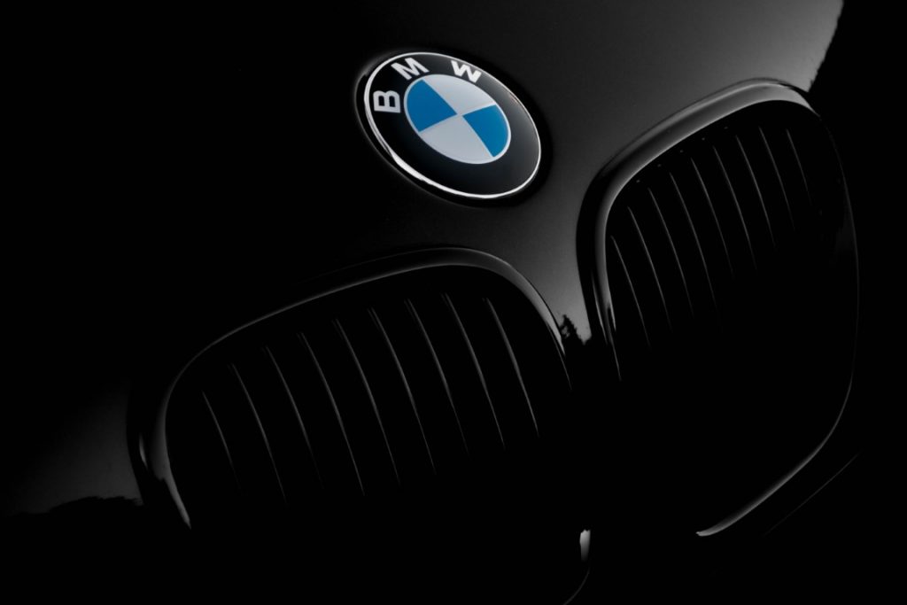 BMW logo on a car in a dark picture