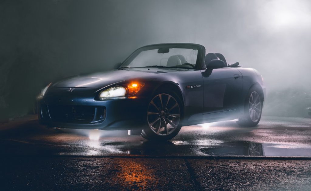 s2000 parked with smoke or steam around it