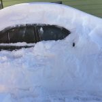 Car under a heavy snowfall