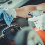 Spraying DIY Car Cleaning Solution in the dashboard