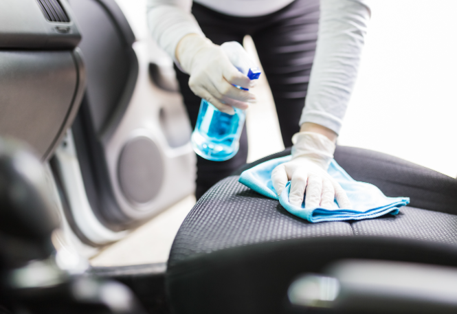 Spraying the car upholstery using the DIY cleaner