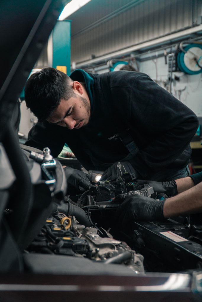 a mechanic looking into an engine bay