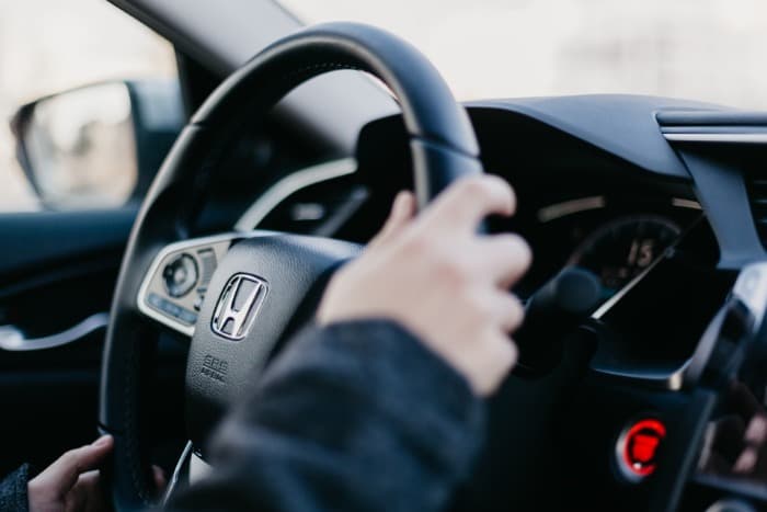 person driving a honda