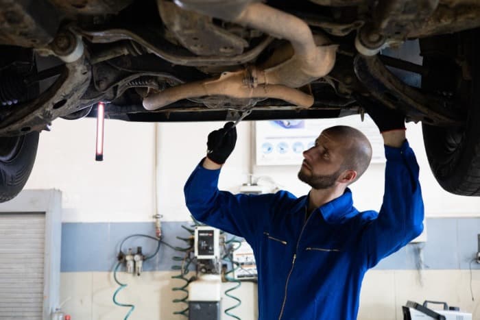 a mechanic checking out a car