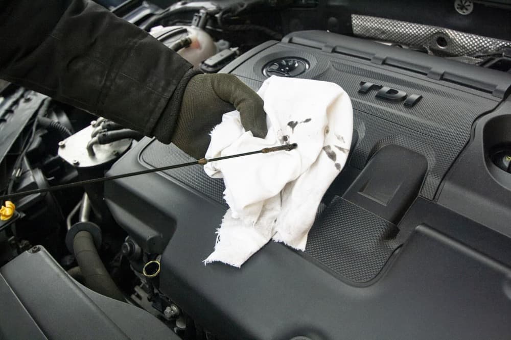checking your oil level on the cars dipstick