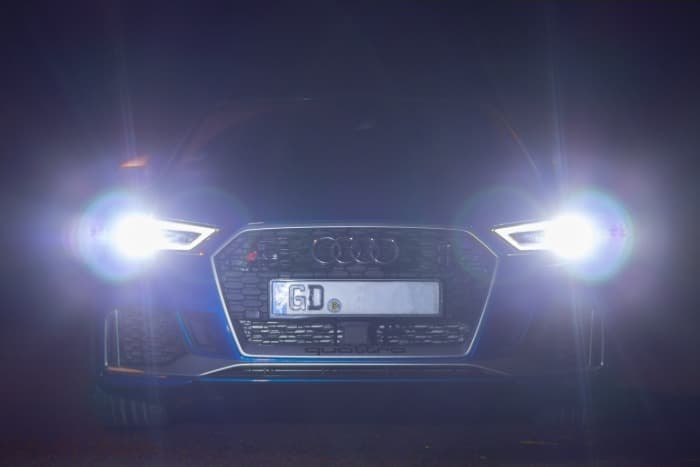 black car with white smoke in lights