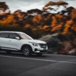 white suv driving on road