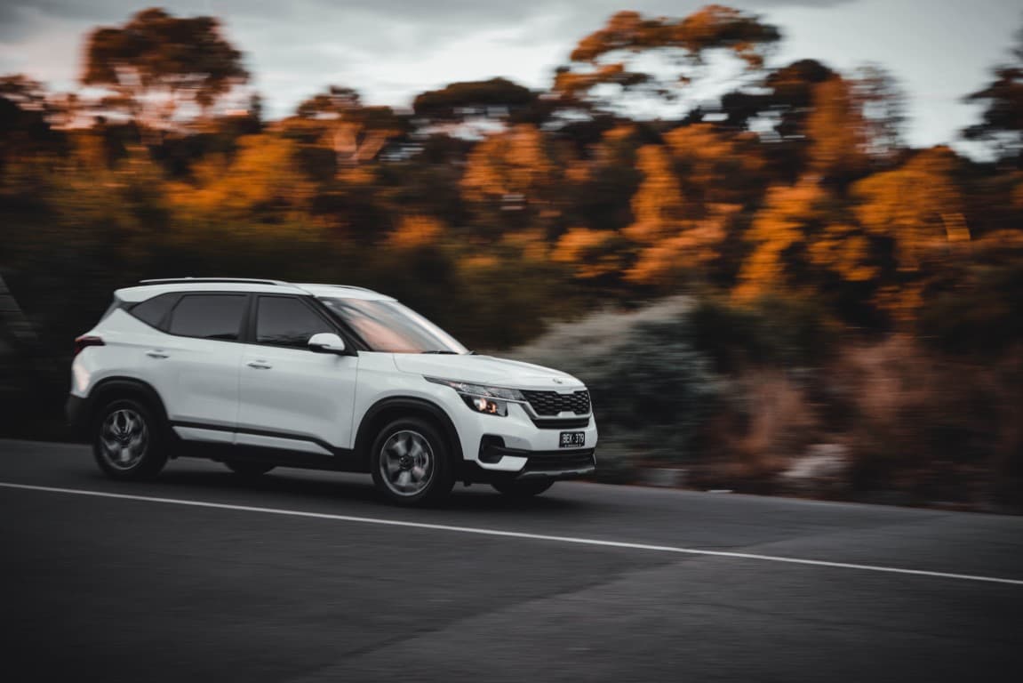 white suv driving on road