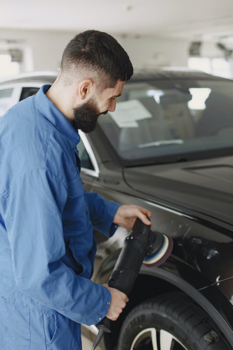 using a dual action polisher on a car