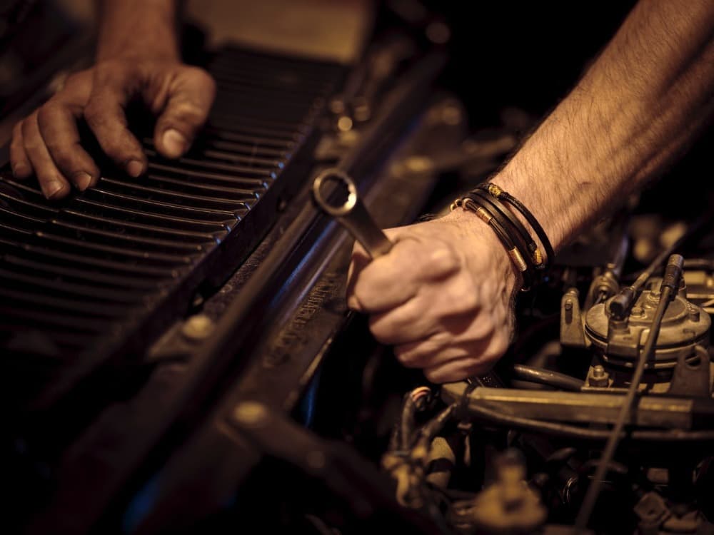 a person using a wrench on a car