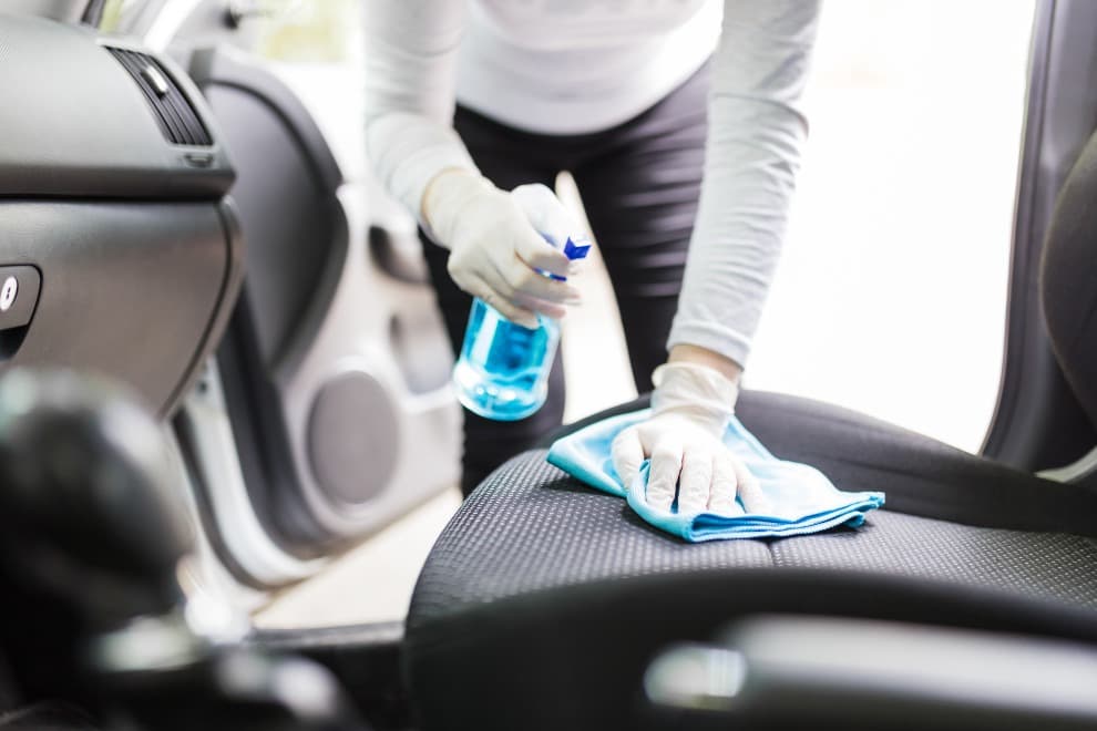 someone Applying the DIY car upholstery cleaner