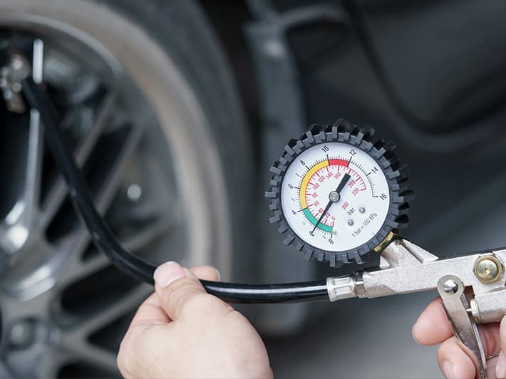 checking tire pressure of the car