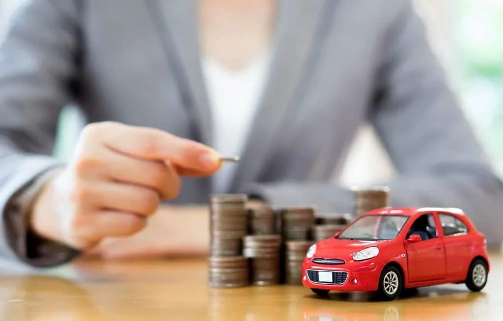 money stacked up beside a car