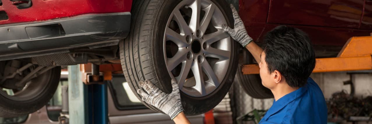 someone rotating the car's tire