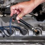 someone checking the car Spark plug
