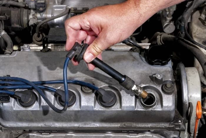 someone checking the car Spark plug