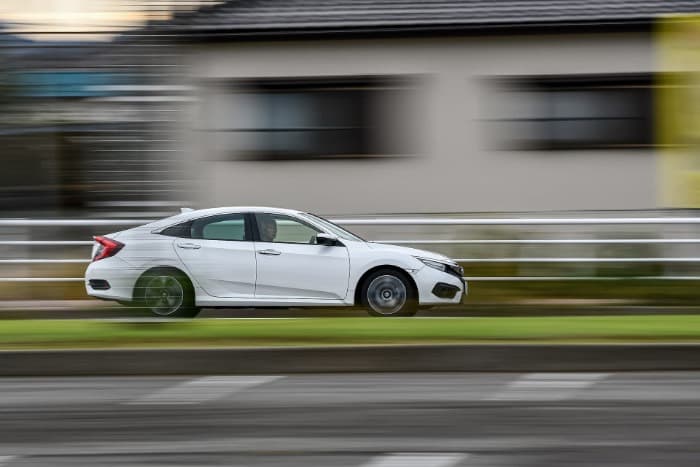 older guy speeding in a newer white civc