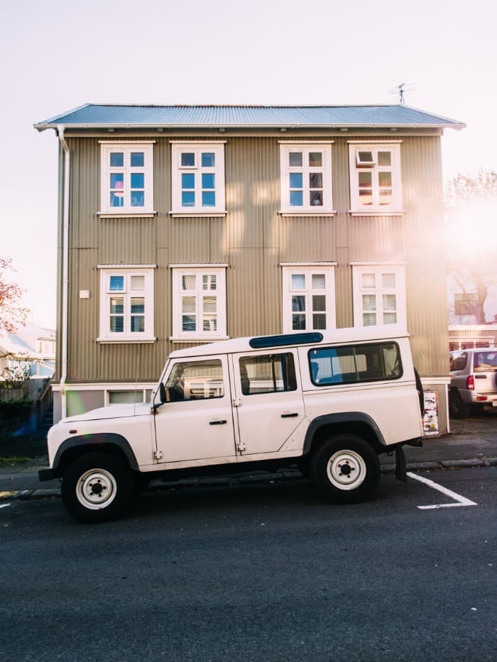 suv parked on a downard sloping road