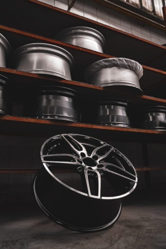 aftermarket rims on shelves in a garage